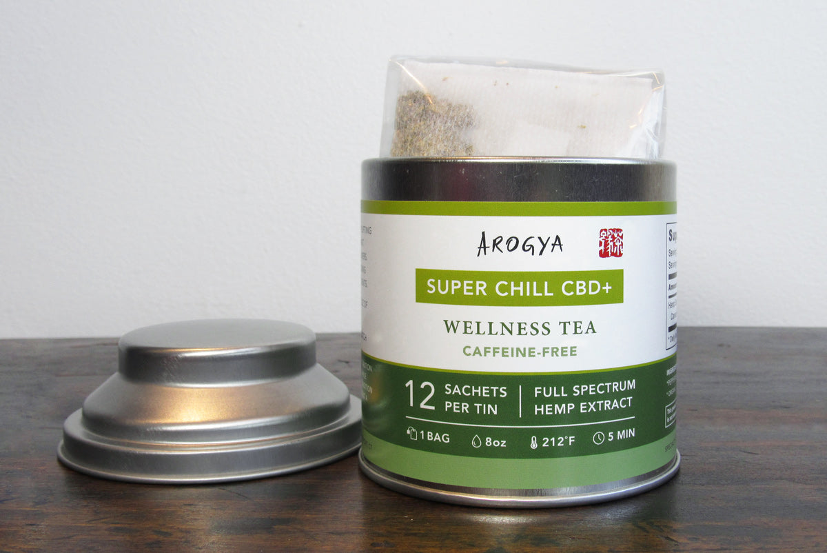 An open tea tin of Super Chill CBD wellness tea containing 12 tea sachets