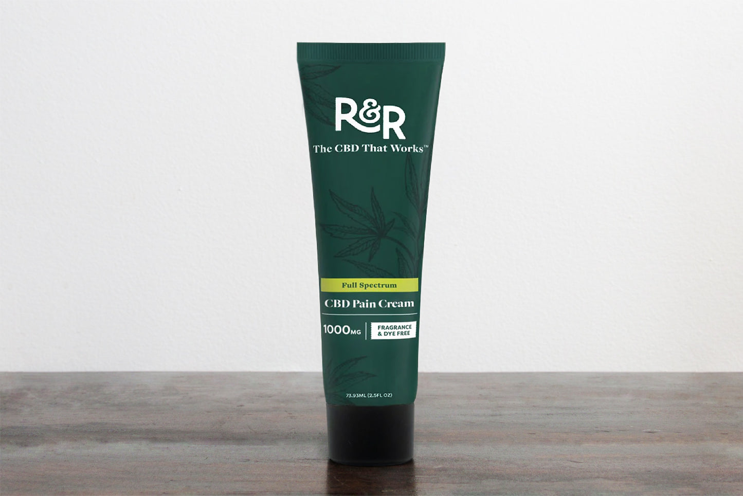 Tube of R&R Medicinals CBD Pain Cream on a wooden surface