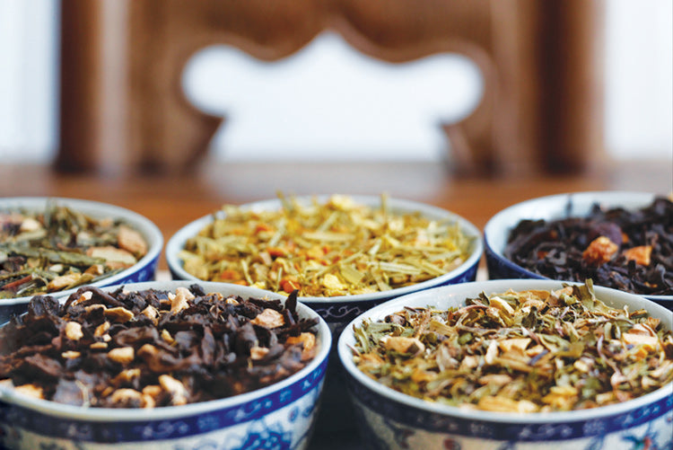 Assorted Arogya loose leaf teas in tea bowls